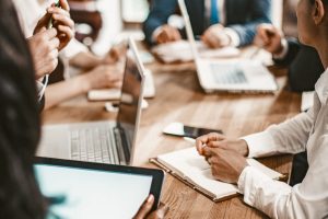 Business Meeting Of Multi-Ethnic Office Workers, Selective Focus On Caucasian Business Woman Holding Pan, Coworkers Team Have Brainstorming In Board Room, Toned Image